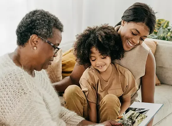 Grandmother, daughter and granddaughter together on couch